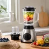 Silver blender with transparent cup body, fruit toppings, lemon green leaves and small accessories details Picture